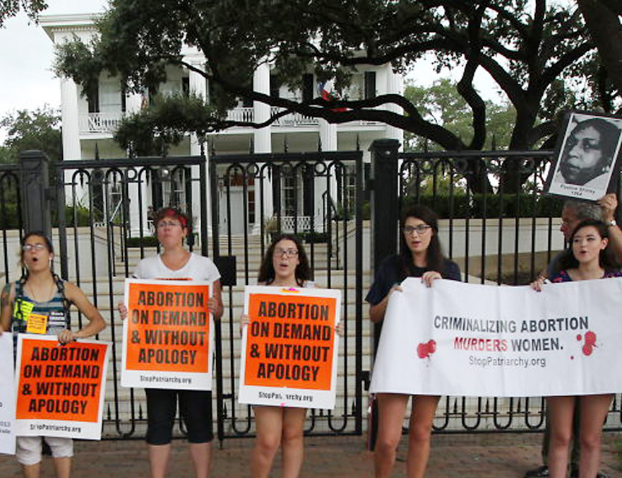 Abortion rights supporters take a stand outside the Texas governor’s mansion on Friday after a federal judge in Austin struck down two provisions of the 2013 Texas law that restricts abortions.