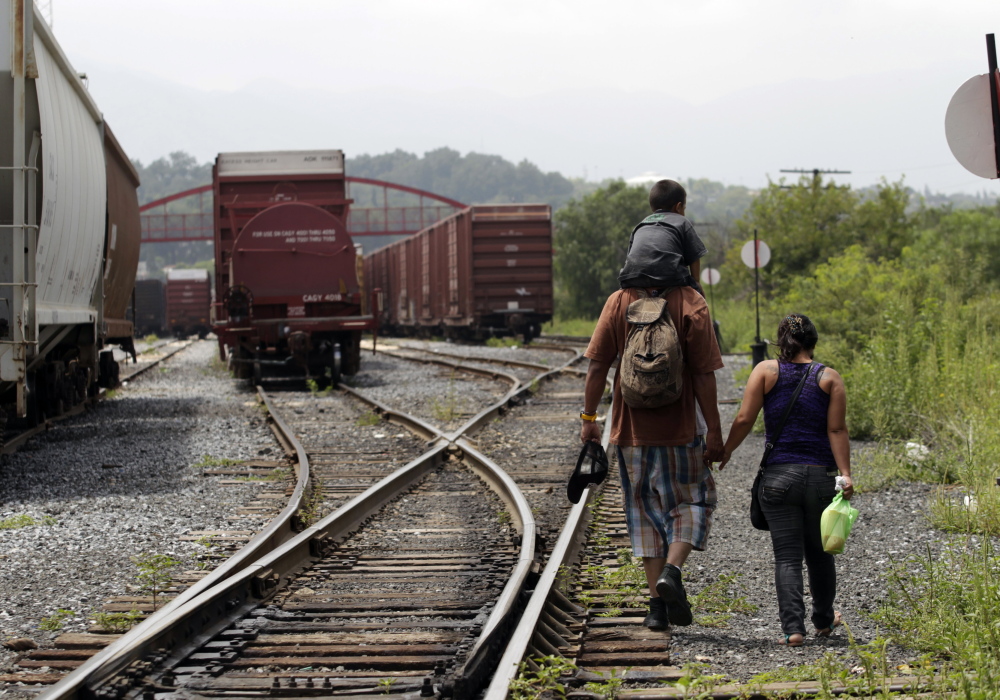 A couple from El Salvador walk with their 3-year-old son on the train tracks in Saltillo early this month. The young family planned to catch the cargo train nicknamed “The Beast” to the United States.
