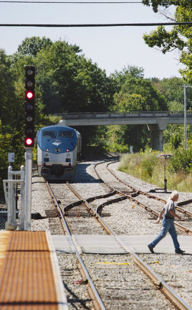 Brunswick resident William Capistran crosses the tracks near the Brunswick train station in 2014.