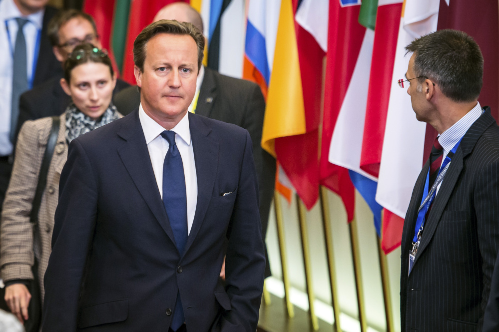 British Prime Minister David Cameron leaves the EU Council building at the end of an EU summit in Brussels early Sunday.