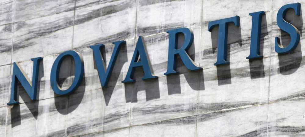 The Novartis logo is shown on a building. Doctors say an as-yet-unnamed drug by the company could quickly change care for people worldwide with heart failure.