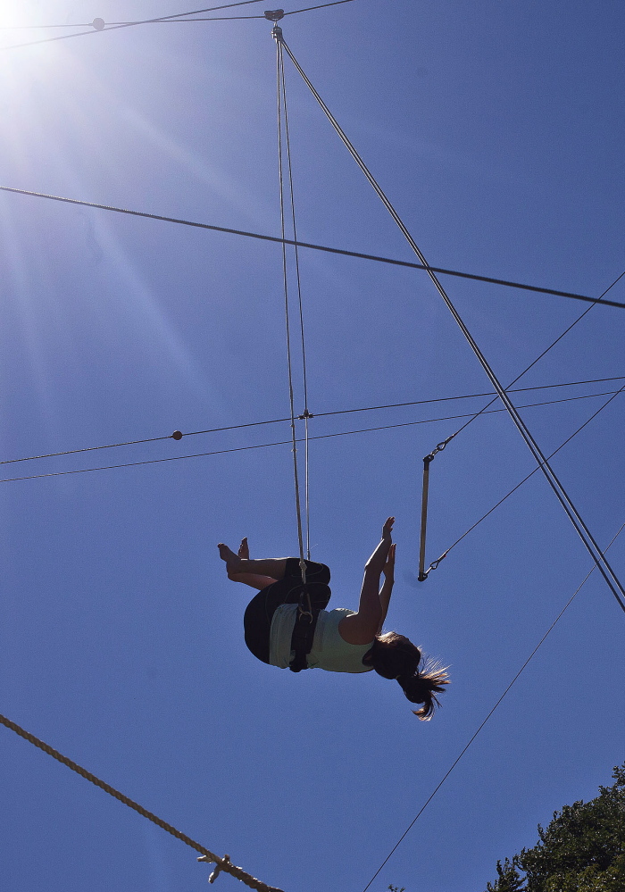 Ashley Asquith lets go of the trapeze bar to perform a backflip at Revolution Trapeze in Waltham, Mass., where a beginner’s class lasts about two hours and costs $49. “Whatever stuff is going on in your life, you have to let go of it,” said fellow student Eileen Frazer.