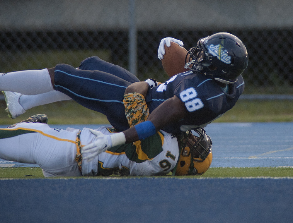 Damarr Aultman of the University of Maine falls into the end zone atop Norfolk State defender Donte Haynsworth, hauling in a 33-yard pass for the only touchdown for either team Saturday night in the Black Bears’ 10-6 victory at Orono.