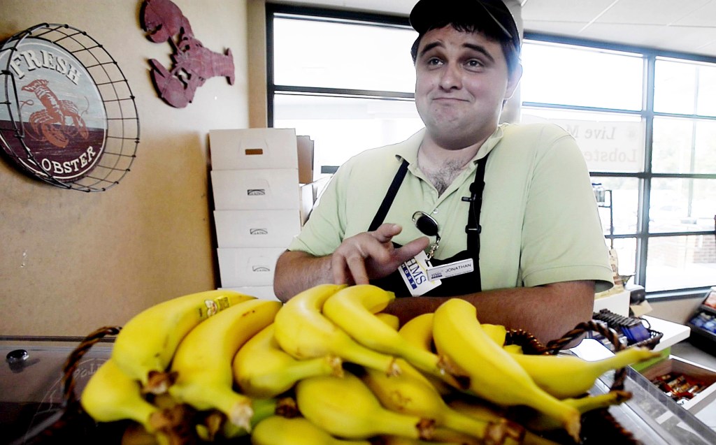 Jonathan Niederer of Biddeford sells bananas – with a song – at the Kennebunk service plaza on the southbound side of the Maine Turnpike. His pitch-perfect selling has earned him the praise of his managers and sales bonuses. “Once I started doing it, I just noticed I got a lot more business, I’d say two to three times more business,” he said. “And it’s because I sing.” Shawn Patrick Ouellette/Staff Photographer
