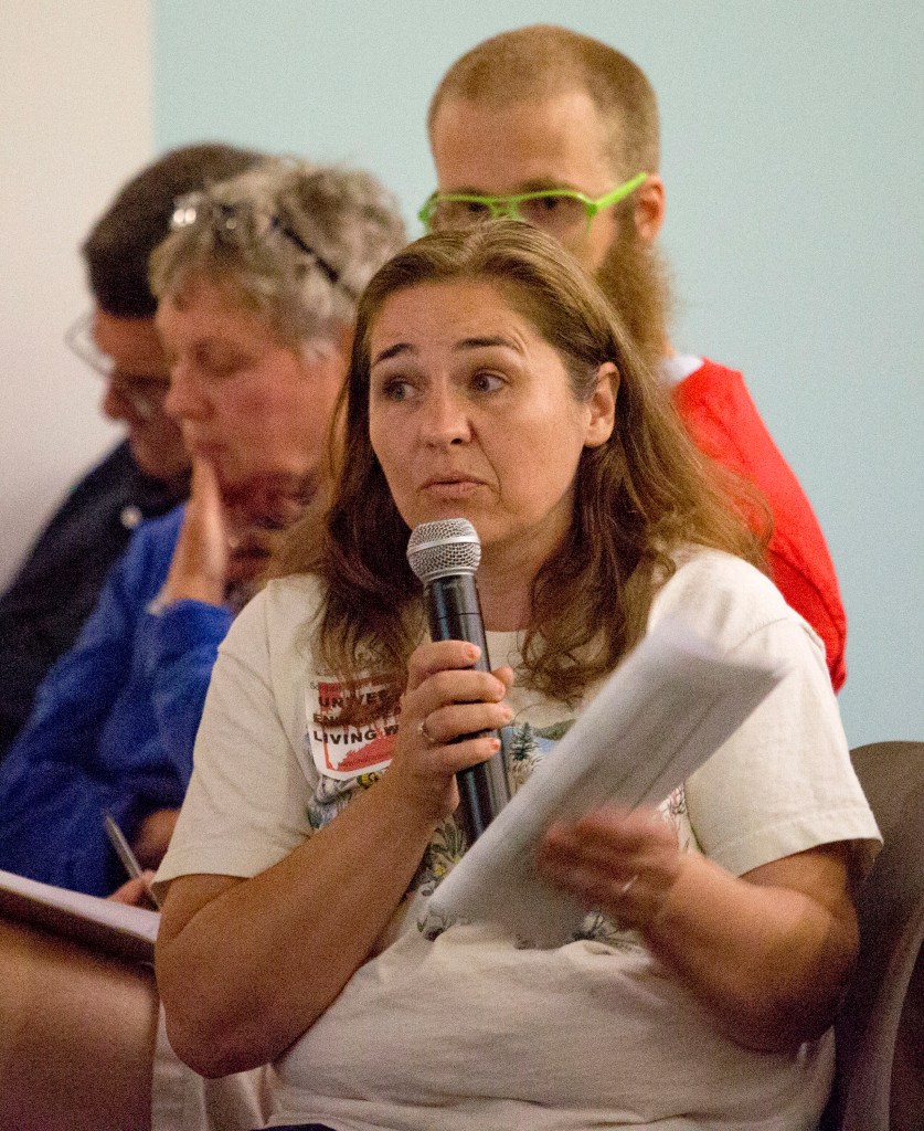 Karen Cairnduff of Portland said she supports raising the minimum wage during a public forum held at the Portland Public Library on Wednesday.