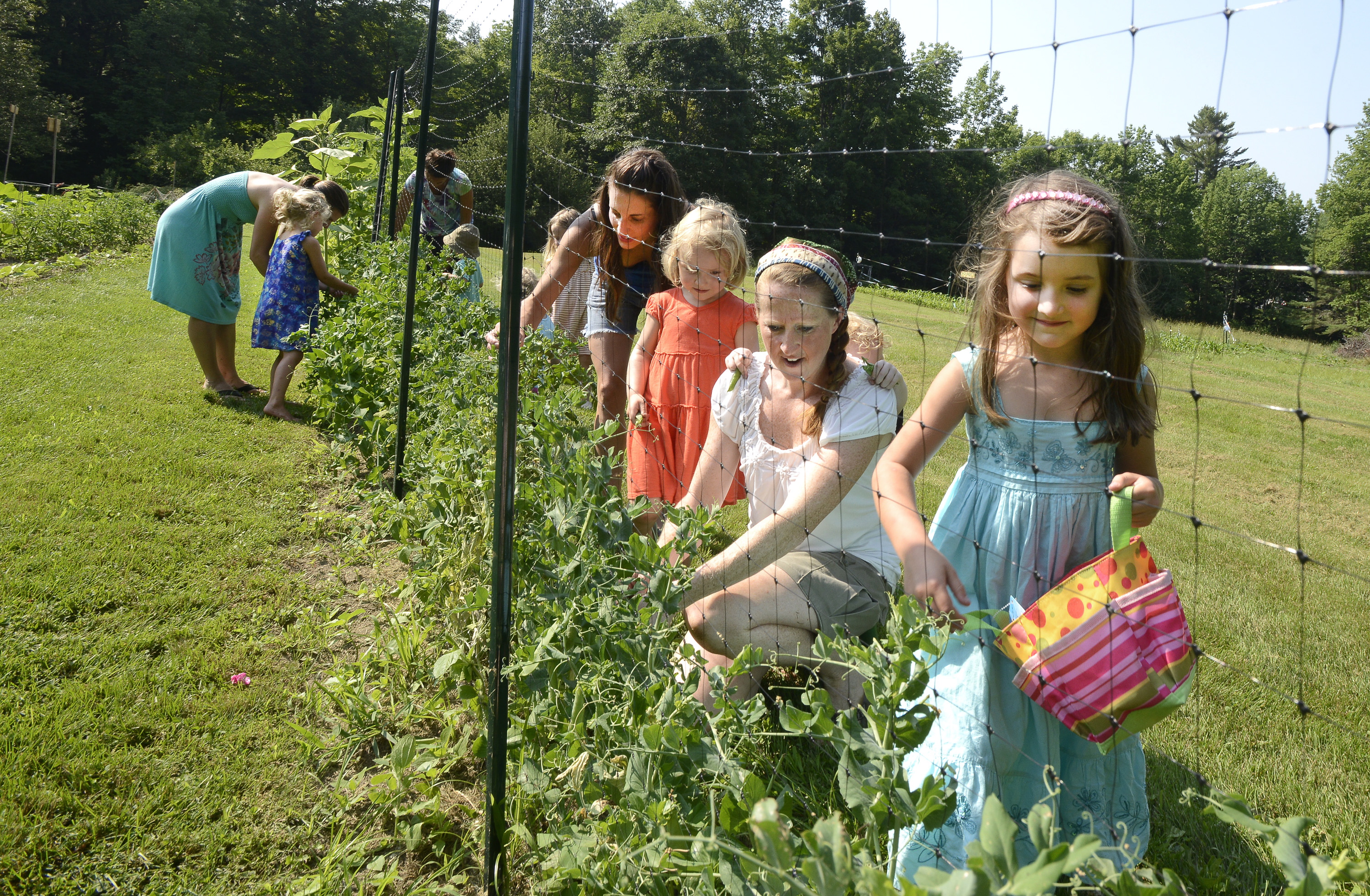 Stephanie O’Neil (in the white shirt) conducts a gardening class for mothers and their children at her farm in West Pownal