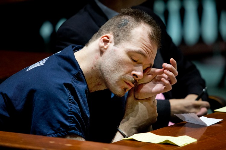 Brian Morin, 31, wipes his eyes in Androscoggin County Superior Court in Auburn on Wednesday before being sentenced to five years in prison followed by 12 years of probation on three counts of felony arson for fires that burned vacant buildings in downtown Lewiston in the spring of 2013.