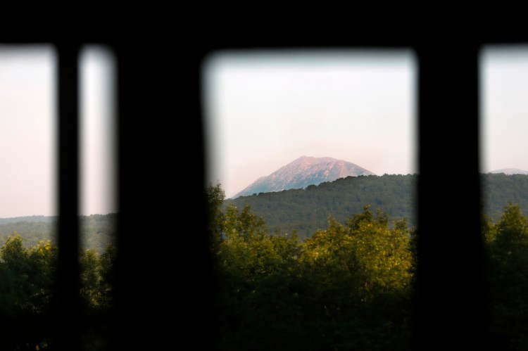 A view of Mount Katahdin through a window at Lunksoos Camps in an August 2014 photo. The camps serve as the base for Elliotsville Plantation Inc., the organization that worked to create a national monument in the North Woods.