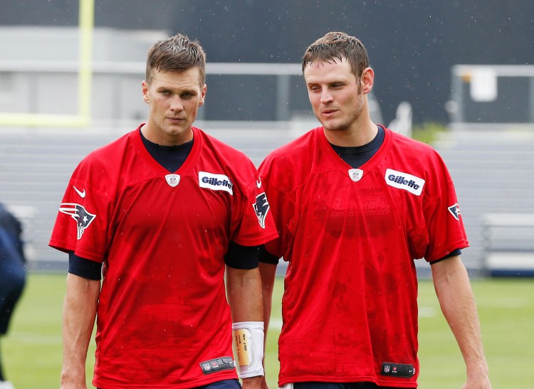 New England Patriots quarterbacks Tom Brady, left, and Ryan Mallet walk off the field after team football practice in Foxborough, Mass., Wednesday, May 29, 2013. The Associated Press