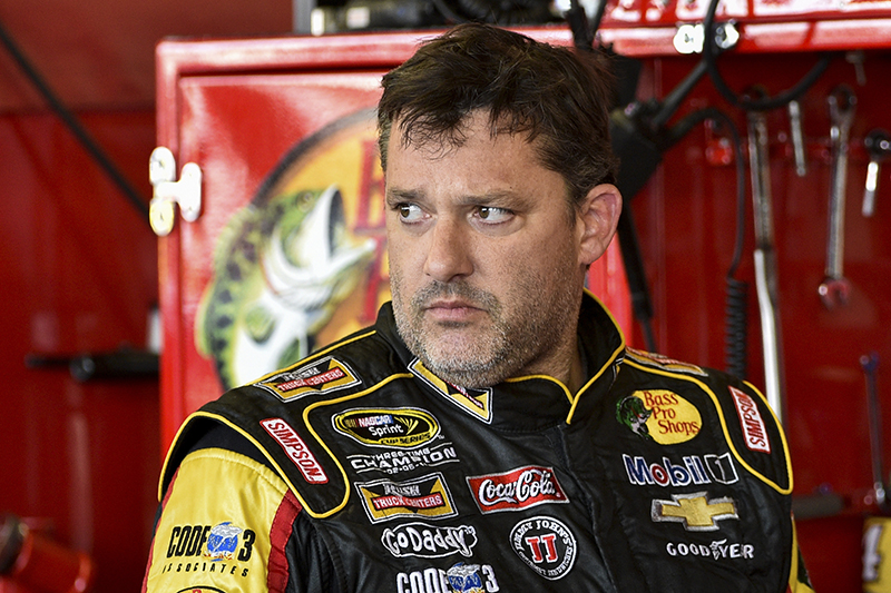Tony Stewart stands in the garage area after a practice session for Sunday's NASCAR Sprint Cup Series auto race at Watkins Glen International, in Watkins Glen N.Y. The Associated Press