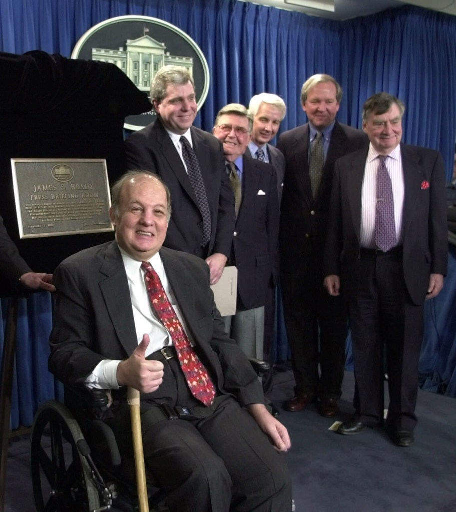 In this Feb. 11, 2000, photo, James Brady, former White House press secretary for Ronald Reagan, appears for the dedication of the new James S. Brady Press Briefing Room at the White House. From left are: Brady, presidential press secretaries Joe Lockhart (Clinton), Jerald terHorst (Ford), Larry Speakes (Reagan), Mike McCurry (Clinton) and Pierre Salinger (Kennedy). The Associated Press