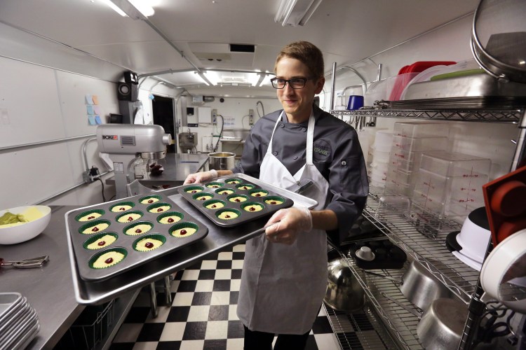 chef Alex Tretter carries a tray of cannabis-infused peanut butter and jelly cups to the oven for baking at Sweet Grass Kitchen, a well-established Denver-based gourmet marijuana edibles bakery which sells its confections to retail outlets throughout the state. Colorado marijuana regulators have drafted an emergency rule aimed at making it easier for new marijuana users to tell how much pot they are eating. The Associated Press
