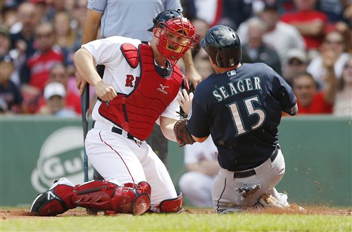 Red Sox's David Ross tags out Mariners' Kyle Seager in the second inning at Fenway Park in Boston on Saturday.
The Associated Press