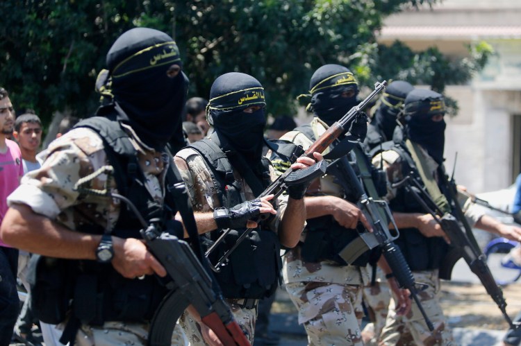 Masked militants of the Islamic Jihad group march during the funeral Wednesday of their comrade Shaaban Al-Dahdouh, whose body was found under the rubble Tuesday in Gaza City.