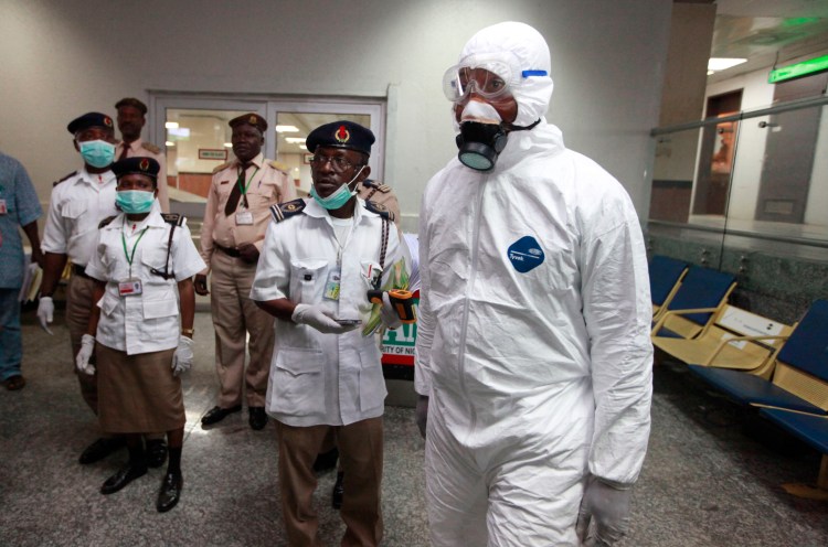 Nigerian health officials wait to screen passengers at the arrival hall of Murtala Muhammed International Airport in Lagos, Nigeria, Monday. Nigerian authorities on Monday confirmed a second case of Ebola in Africa's most populous country. The Associated Press