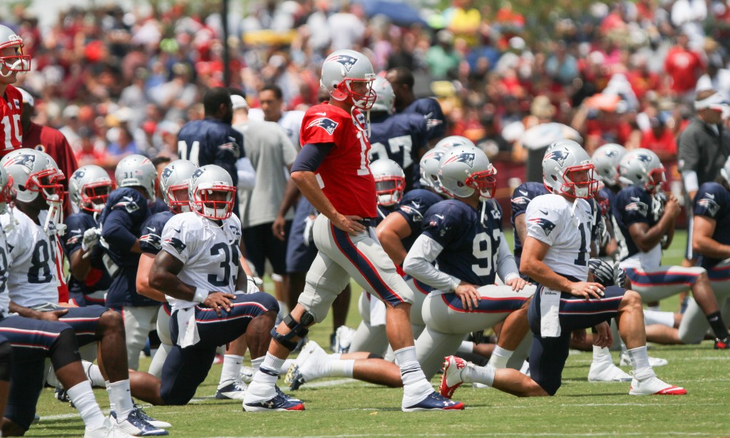 New England Patriots QB Tom Brady, center, works out before a training camp scrimmage between  New England and Washington in Richmond, Va., Tuesday. The Associated Press