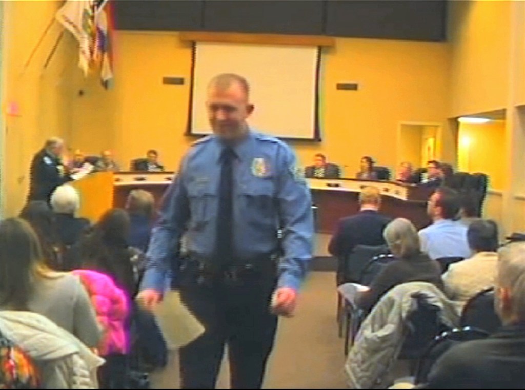 In this  Feb. 11, 2014 image from video released by the City of Ferguson, Mo., officer Darren Wilson attends a city council meeting in Ferguson.  Police identified Wilson, 28, as the police officer who shot Michael Brown on Aug. 9, 2014, sparking over a week of protests in the suburban St. Louis town. The Associated Press
