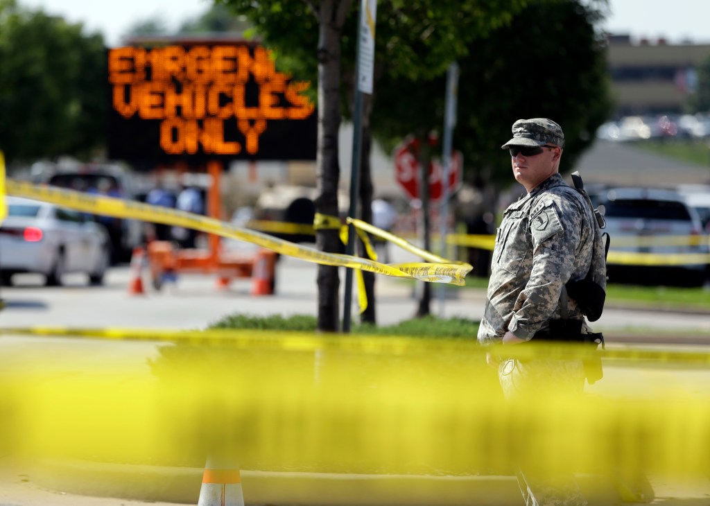 A member of the Missouri National Guard stands guard at a police command post Tuesday in Ferguson, Mo. Ferguson's leaders urged residents Tuesday to stay home after dark to "allow peace to settle in." 