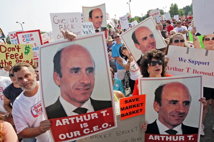 Market Basket supermarket employees and supporters hold a rally July 25, 2014, in Tewksbury, Mass., to back ousted former CEO Arthur T. Demoulas. The Associated Press