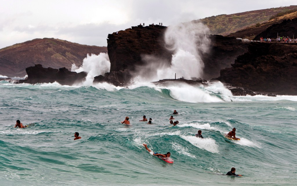 Surfers and body boarders wait for waves at Sandy Beach Park in Honolulu on Friday. Tropical Storm Iselle caused higher-than-normal waves in parts of the island of Oahu. The Associated Press