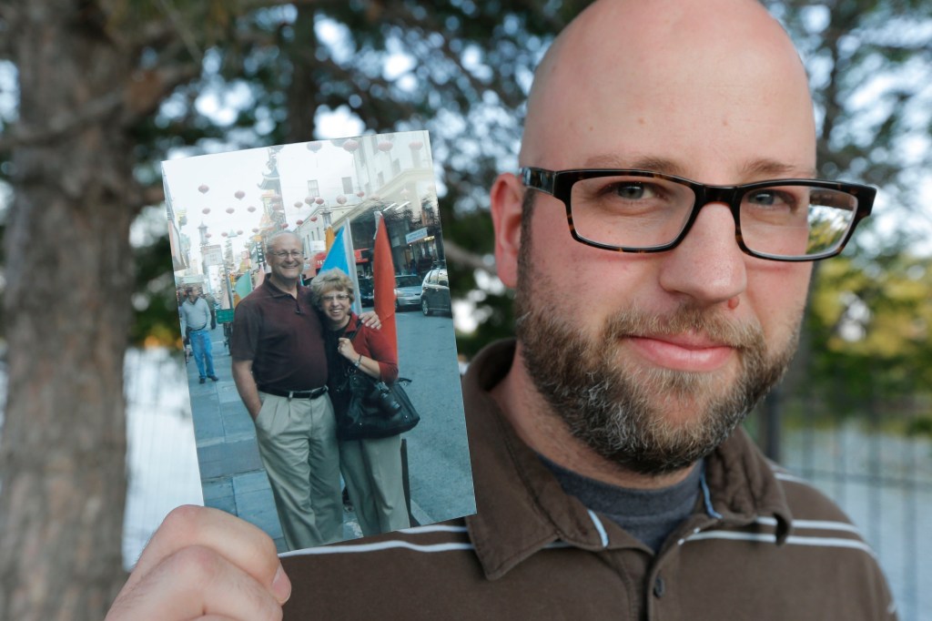 Jeremy Writebol holds a photograph of his mother and father in Wichita, Kan. His mother, Nancy Writebol, is a missionary who has been stricken with Ebola. 