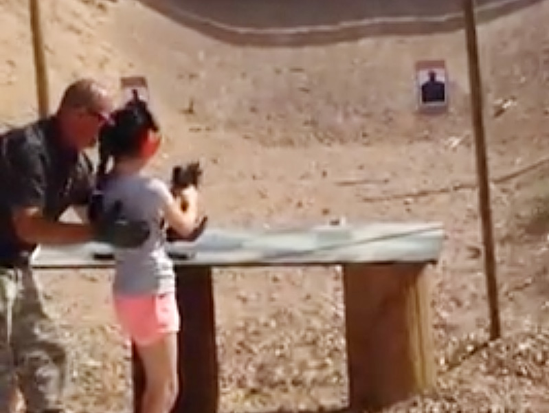 Instructor Charles Vacca shows a 9-year old girl how to use an Uzi. Vacca was standing next to the girl on Monday at the Last Stop range in Arizona when the girl squeezed the trigger, causing the Uzi to recoil upward and shoot Vacca. Gun enthusiasts and safety advocates in Maine agree that such an accident is unlikely to occur here.