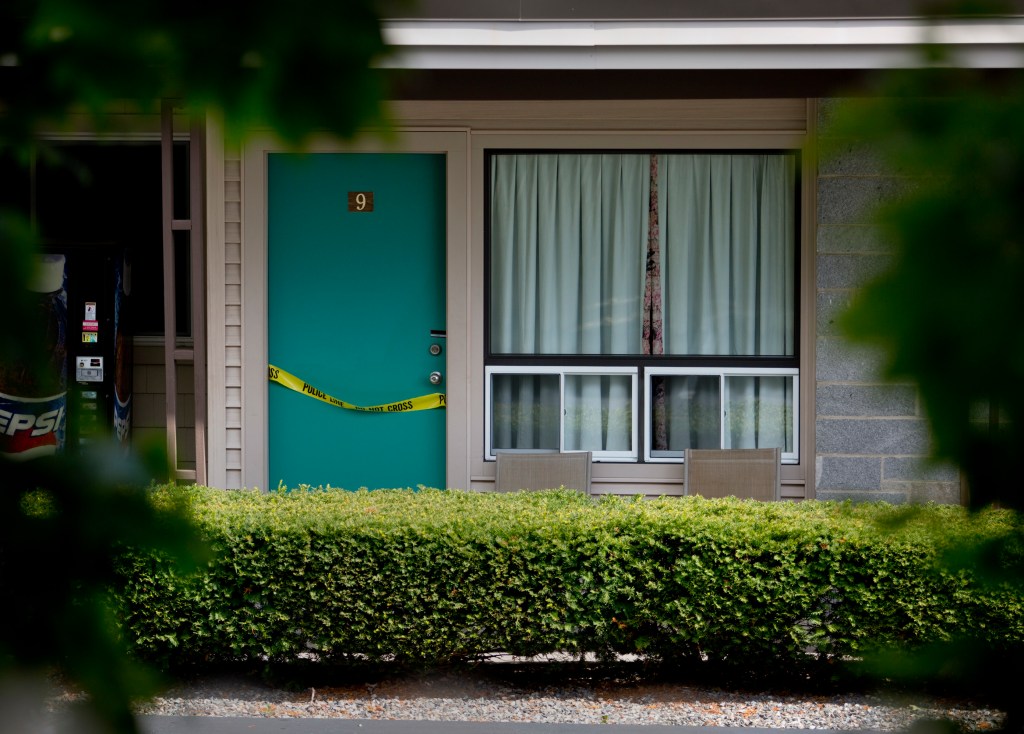 Crime scene tape was draped over the door of Room 9 of the Sleepy Hollow Motel in Biddeford Wednesday. Gabe Souza / Staff Photographer