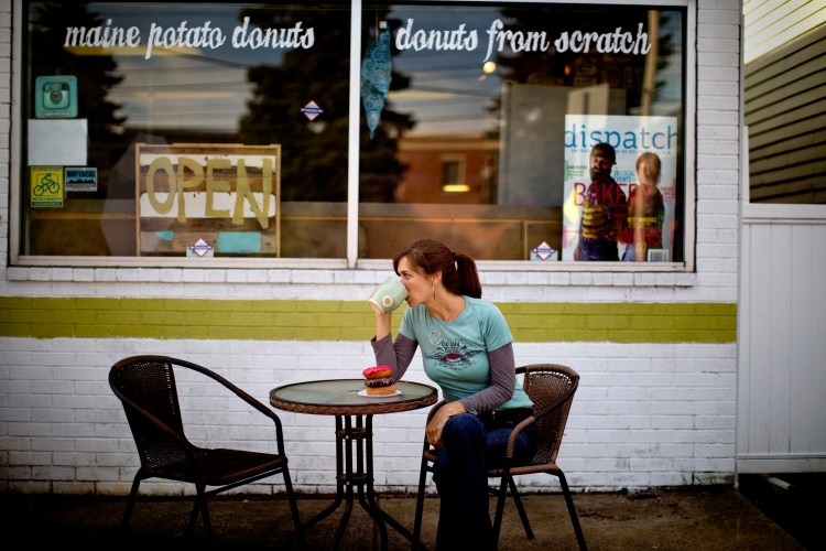 Leigh Kellis, owner of The Holy Donut on Park Avenue in Portland, sits in front of a stack of three varieties in 2014.
