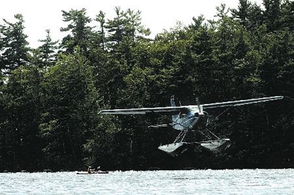 A float plane piloted by Bill McKay makes a landing approach on Messalonskee Lake in Oakland in this August 2006 photo. Morning Sentinel file photo