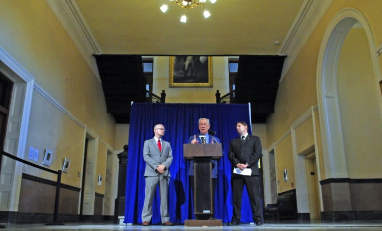 From left, Ben Grant, chairman of the Maine Democratic Party, Rep. Richard Farnsworth, D-Portland, and Sen. Troy Jackson, D-Allagash, take part in a news conference Thursday outside the governor’s office in the State House Hall of Flags.