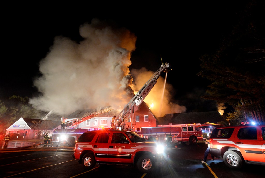 Firefighters battle a three-alarm fire Monday night at the Scarborough Commons commercial building at 153 Route 1.