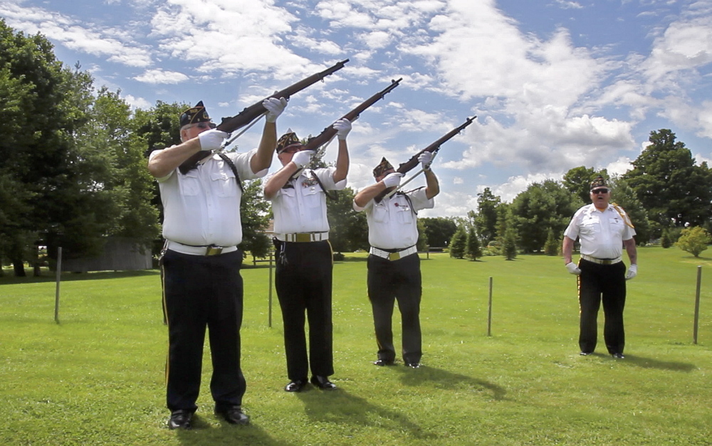 Jim Palmer, Patrick Eisenhart and Normand Bernier perform a rifle salute during a funeral at the Maine Veterans’ Memorial Cemetery in Augusta. At right is Jim Keenan.