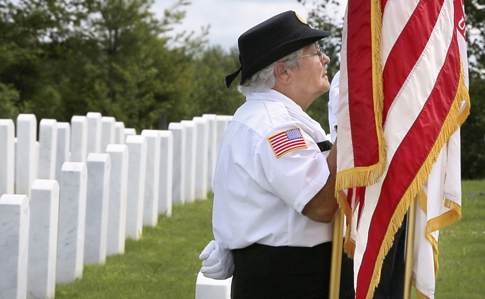 Elaine Brochu of Windsor holds a U.S. flag during a funeral at the Maine Veterans’ Memorial Cemetery in Augusta. Brochu is a member of the Kennebec County Veterans Honor Guard, a volunteer group of veterans who, since 2003, have attended over 1,000 funerals of veterans in Maine.