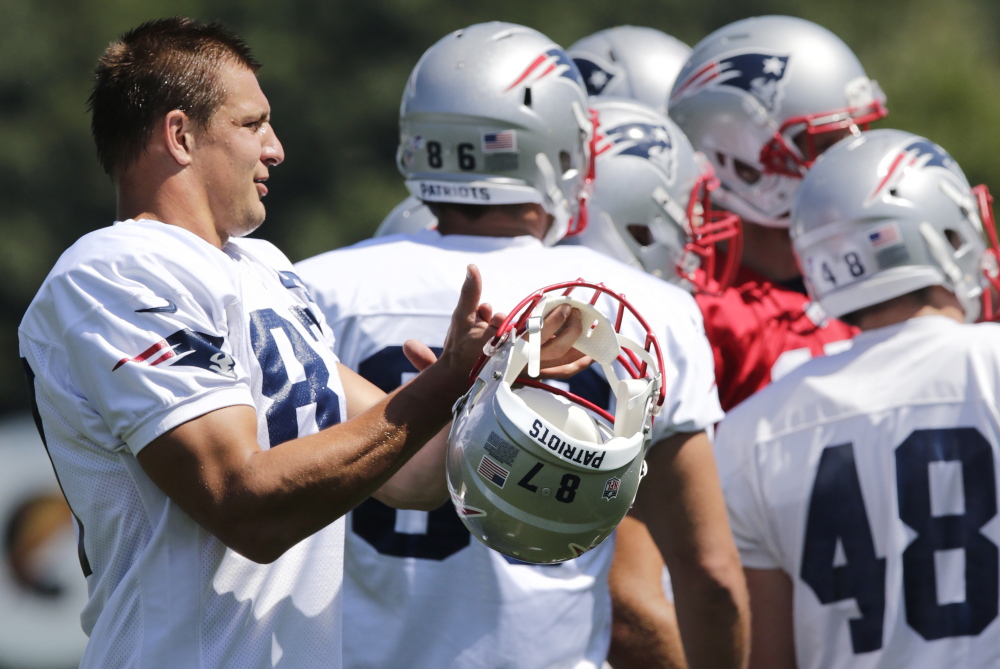 New England Patriots tight end Rob Gronkowski applauds after a play during an NFL football practice in Foxborough, Mass. on Aug. 20.