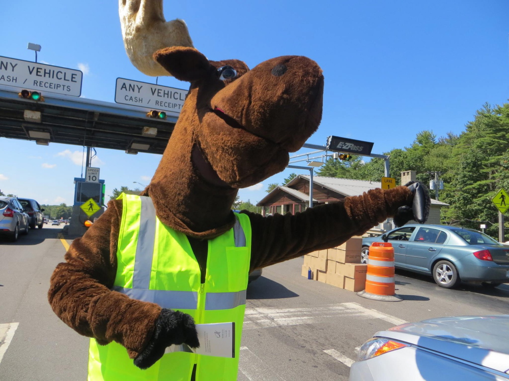 Miles the Turnpike Moose waves as cars get ready to go through the York toll plaza Monday afternoon. Miles and turnpike authority workers handed out 25,000 free copies of the Farmers’ Almanac to mark the end of Labor Day weekend.
Photo courtesy of Maine Turnpike Authority