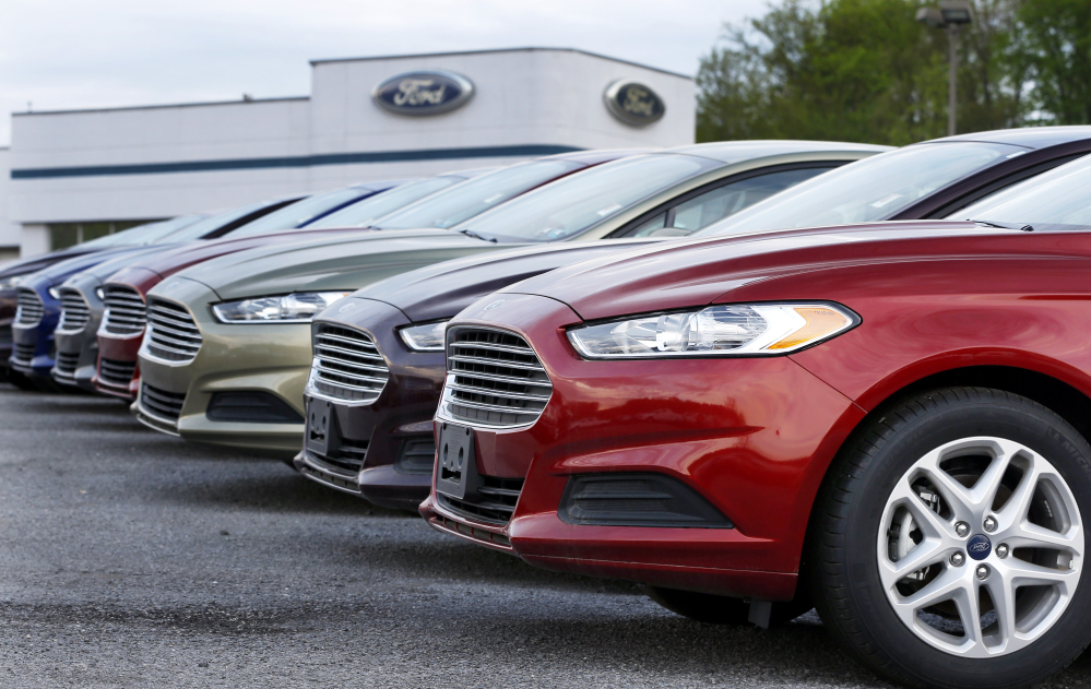 In this Wednesday, May 8, 2013 file photo, a row of new 2013 Ford Fusions are on display at an automobile dealership in Zelienople, Pa.