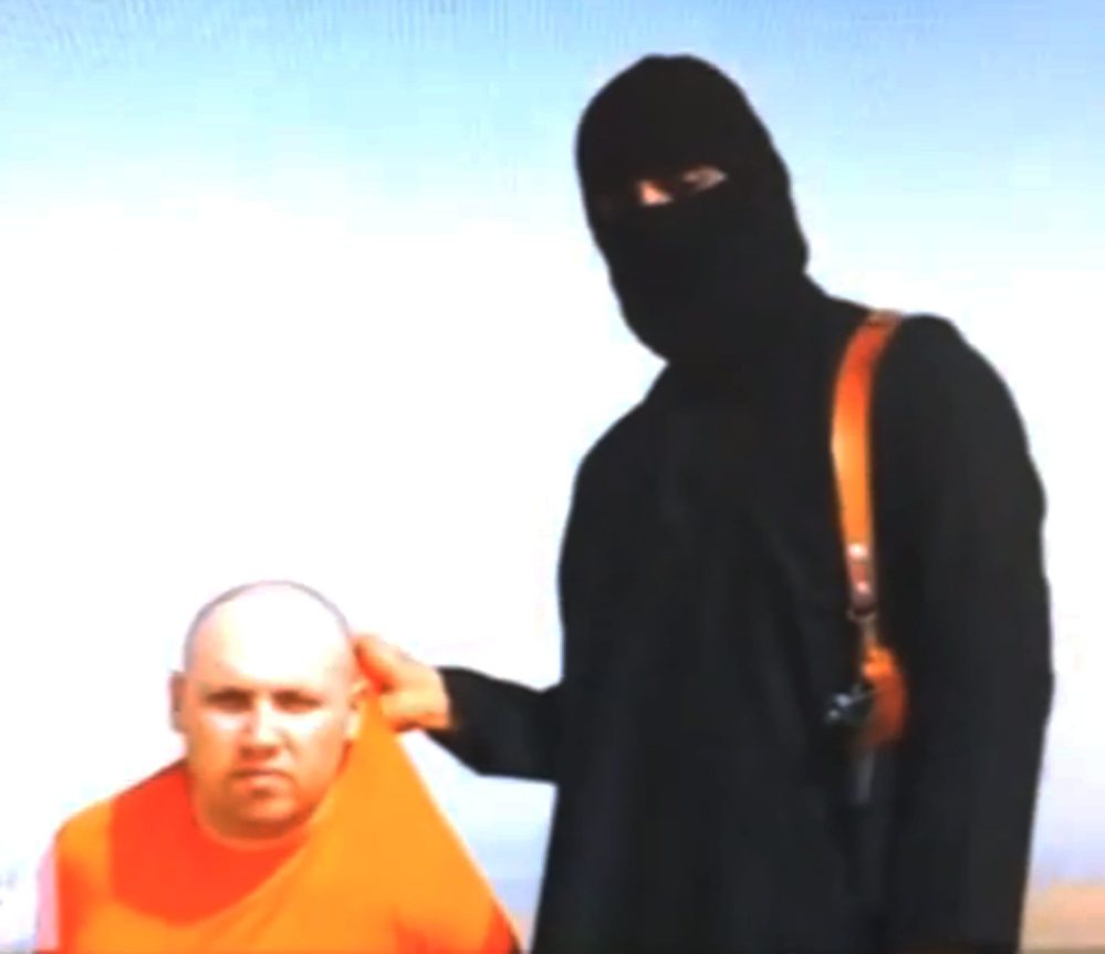 This still image from an undated video released by Islamic State militants on Aug. 19 purports to show journalist Steven Sotloff being held by the militant group.