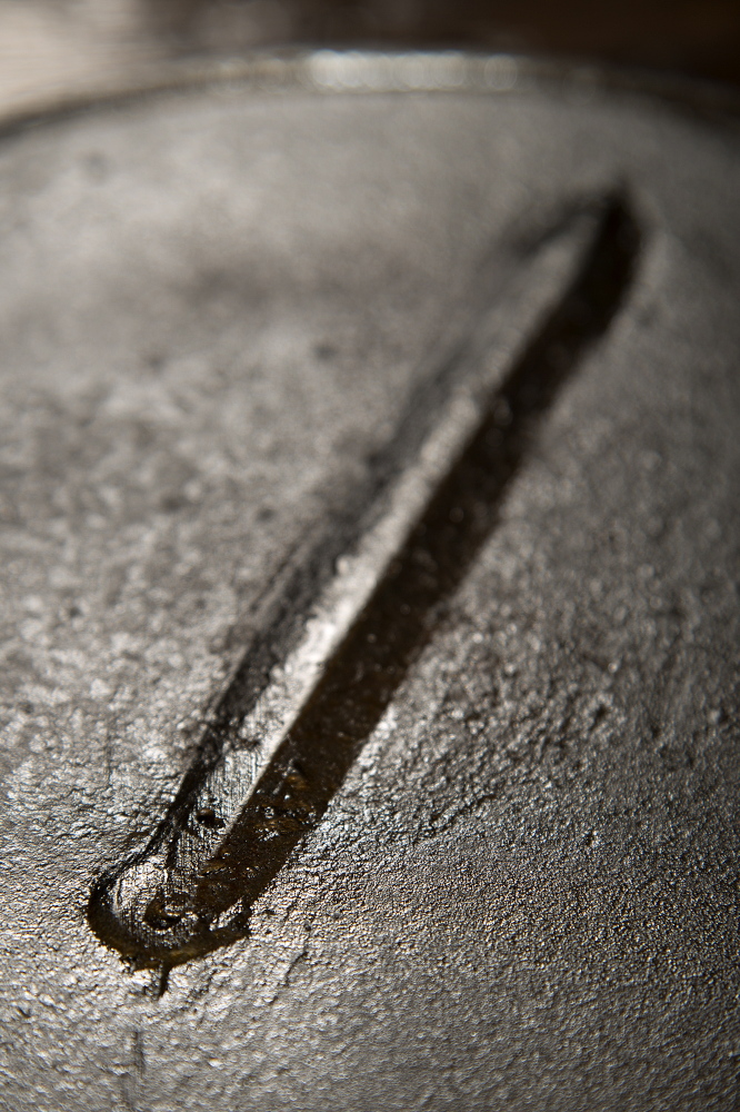 Detail shows the casting mark at the bottom of one of the “7” cast iron skillets.