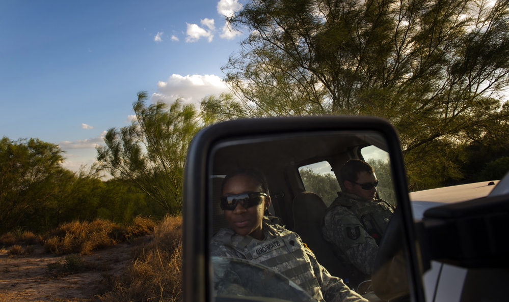 Members of the National Guard watch for unusual activity along the U.S.-Mexico border in Rio Grande City, Texas. About 400 members of the Texas National Guard have been deployed and about 1,000 will eventually be on the lookout for undocumented immigrants.

