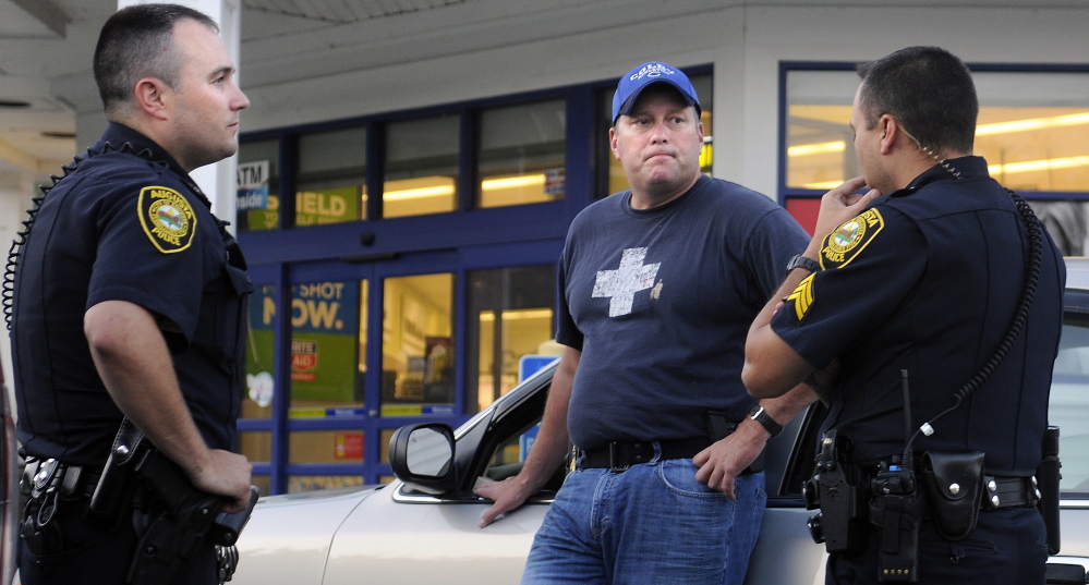 Augusta police Sgt. Vincente Morris, right, speaks with Augusta police Lt. Chris Massey, center, and Officer Jess Brann on Tuesday outside the Rite Aid on North Belfast Avenue in Augusta. As police were investigating an attempted robbery at the pharmacy, the Rite Aid on Hospital Street in Augusta was robbed.