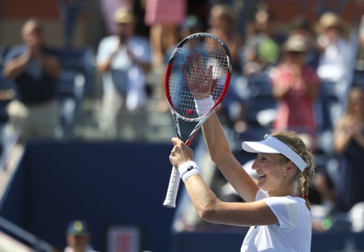 Ekaterina Makarova, of Russia, waves to the crowd after defeating Victoria Azarenka, of Belarus, in two sets during the quarterfinals of the 2014 U.S. Open tennis tournament, Wednesday in New York.