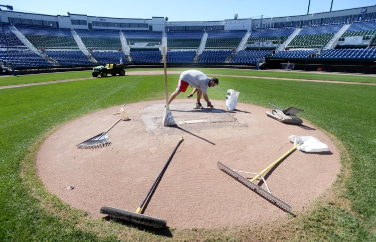 Jason Cooke, assistant head groundskeeper, works on the pitcher's mound Thursday as the crew prepares Hadlock Field for the upcoming Portland Sea Dogs playoff games. Shawn Patrick Ouellette / Staff Photographer