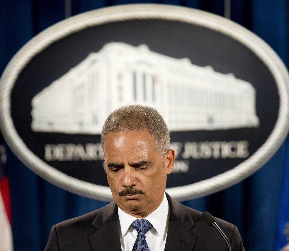 Attorney General Eric Holder pauses during a news conference at the Justice Department in Washington on Thursday, where he announced that the Justice Department’s civil rights division will launch a broad investigation in the Ferguson, Mo., Police Department.