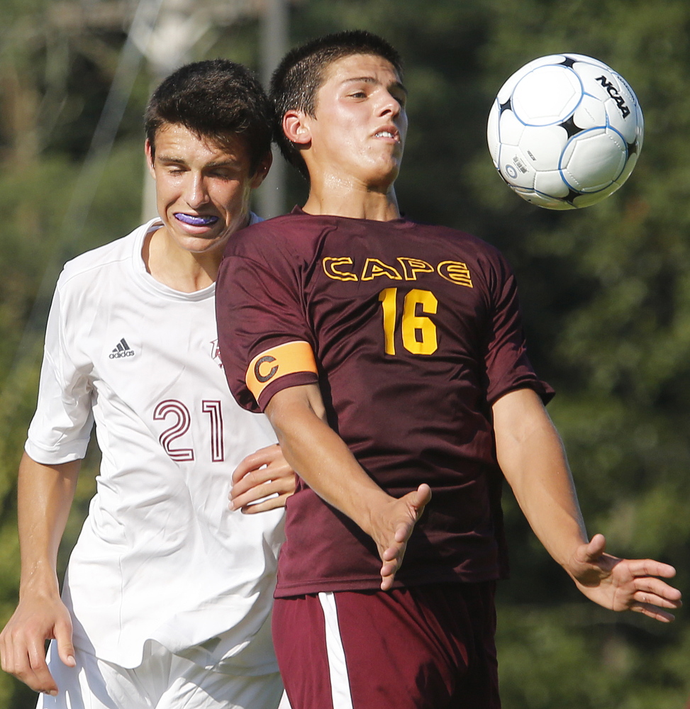 Noah Haversat of Cape Elizabeth chests down the ball after gaining gets position in front of Callum Gould of Freeport.