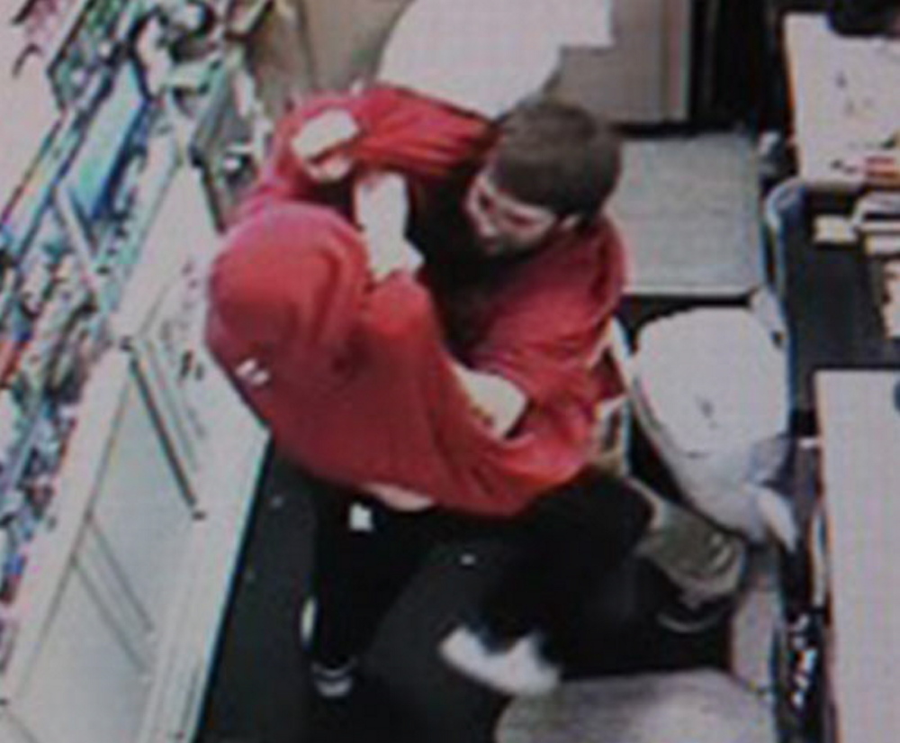 Ronald Castrello, red hoodie, tangles with a clerk at Circle K convenience store in South Portland early Saturday morning. The clerk wrestled Castrello to the ground. Castrello was arrested and charged with Class B robbery.
