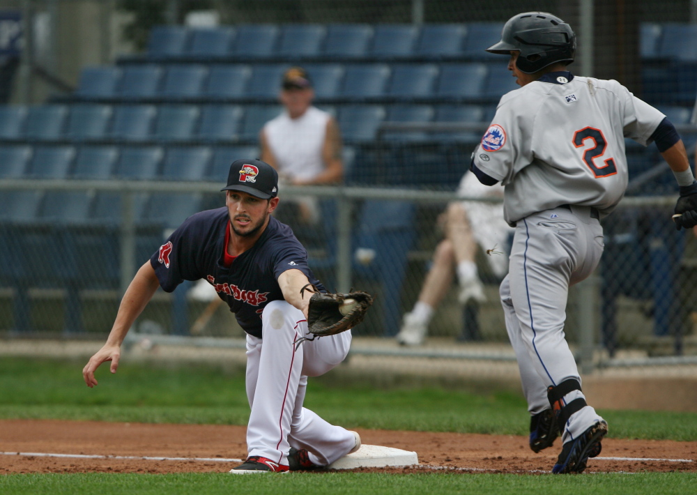 Portland Seadogs’ Stefan Welch, left, tags out Binghamton Mets’ Wilfredo Tovar at first base Saturday, during the 2nd inning against the Mets at Hadlock Field in Portland, Maine. Joel Page/Staff Photographer
