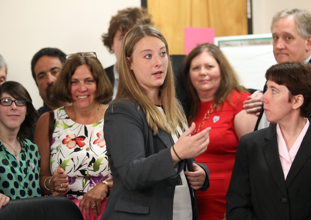New Hampshire victim witness advocate Brigit Feeney, 26, center, talks with the family and friends of slain college student Lizzi Marriott before an August news conference at Strafford County Superior Court in Dover, N.H. “It’s about being able to help people through some of the most horrific things they could ever go through in their lives,” Feeney said of her work.