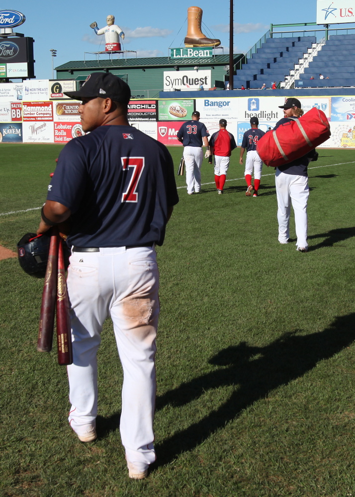 Portland Sea Dogs’ Heiker Meneses joins teammates walking to the clubhouse Sunday following their season-ending playoff loss to the Binghamton Mets at Hadlock Field.