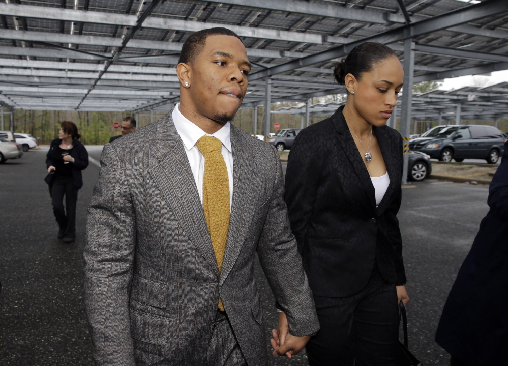 Baltimore Ravens football player Ray Rice holds hands with his wife, Janay Palmer, in May. Other players have weighed in on his suspension following the release of a video that appears to show him knocking Janay Palmer to the ground.