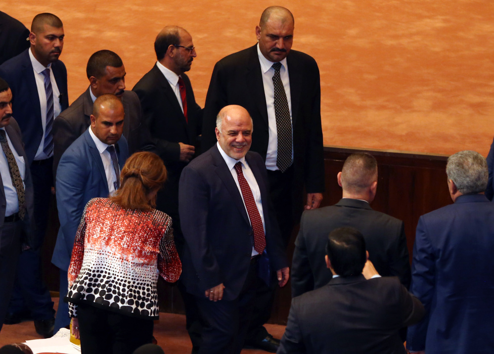 Iraq’s new Prime Minister Haider al-Abadi, center, attends the Parliament session to submit his government in Baghdad, Iraq, on Monday.